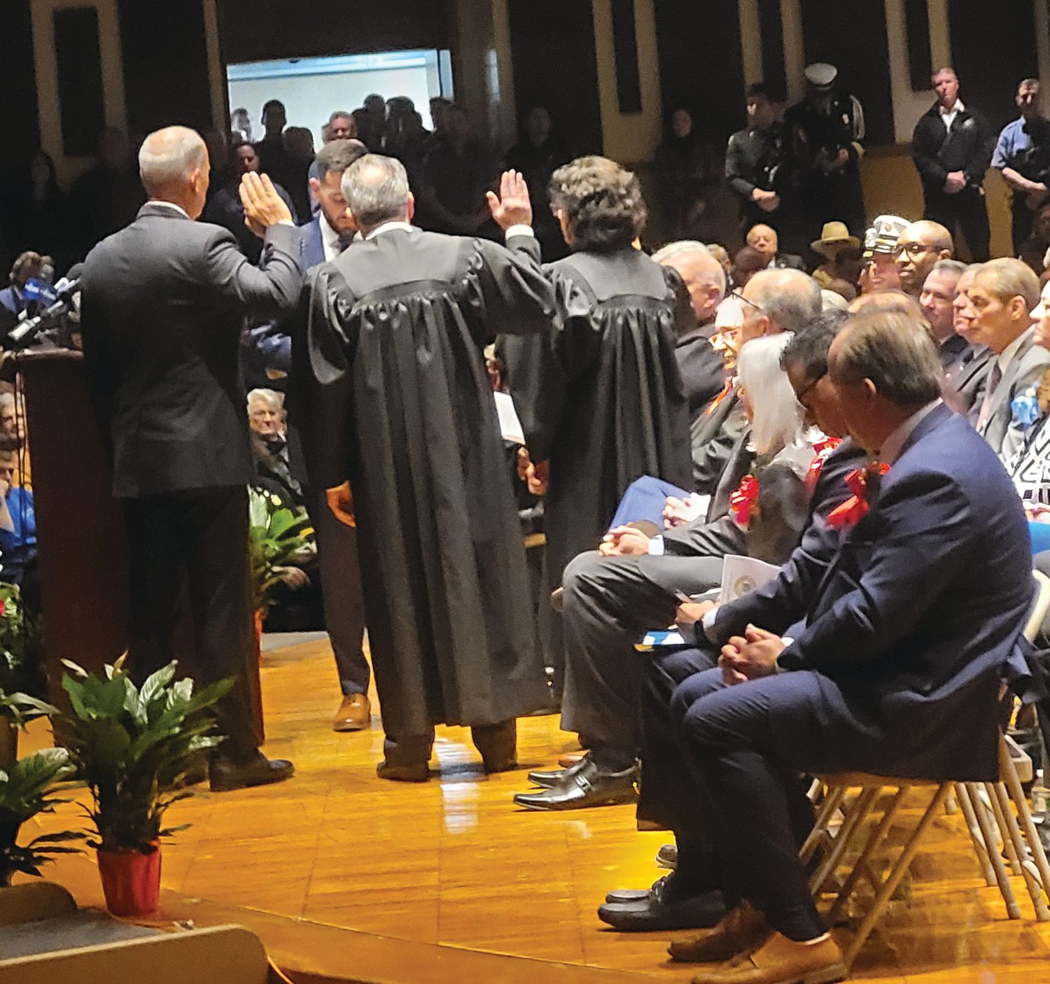 NEW JUDGES: Joseph Polisena Jr. swore in three judges on Inauguration Night, Jan. 9: Judge of the Johnston Municipal Court, David aRusso; Frank Manni as Auxiliary Judge; and Priscilla Facha DiMaio, Probate Judge. Town Council member Robert Civetti is seated on the right, watching the oath delivered following his vote against the appointment of aRusso, now-former Judge Jacqueline M.  Grasso’s replacement.